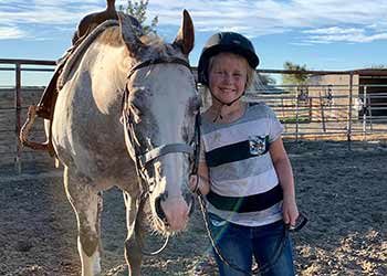 Dal Porto Saddle Club student standing with lesson horse 2023