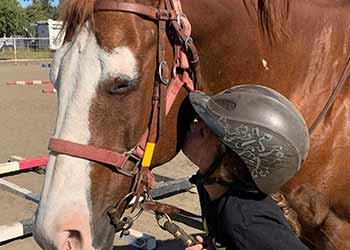 Dal Porto Saddle Club student kissing horse